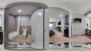 A modern bathroom with a shower, toilet, and sink. - Scottish Inns Katy (Katy)