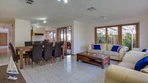 A spacious living room with a dining area, a sofa set, and a coffee table. - SHORE THING - FAMILY BEACH RETREAT  (Tootgarook)