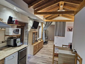 A compact kitchen with a microwave, coffee maker, and a small refrigerator.