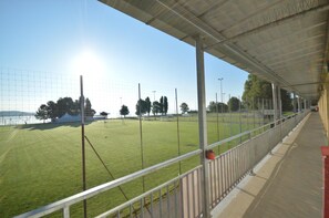 A sports field with a covered spectator area.