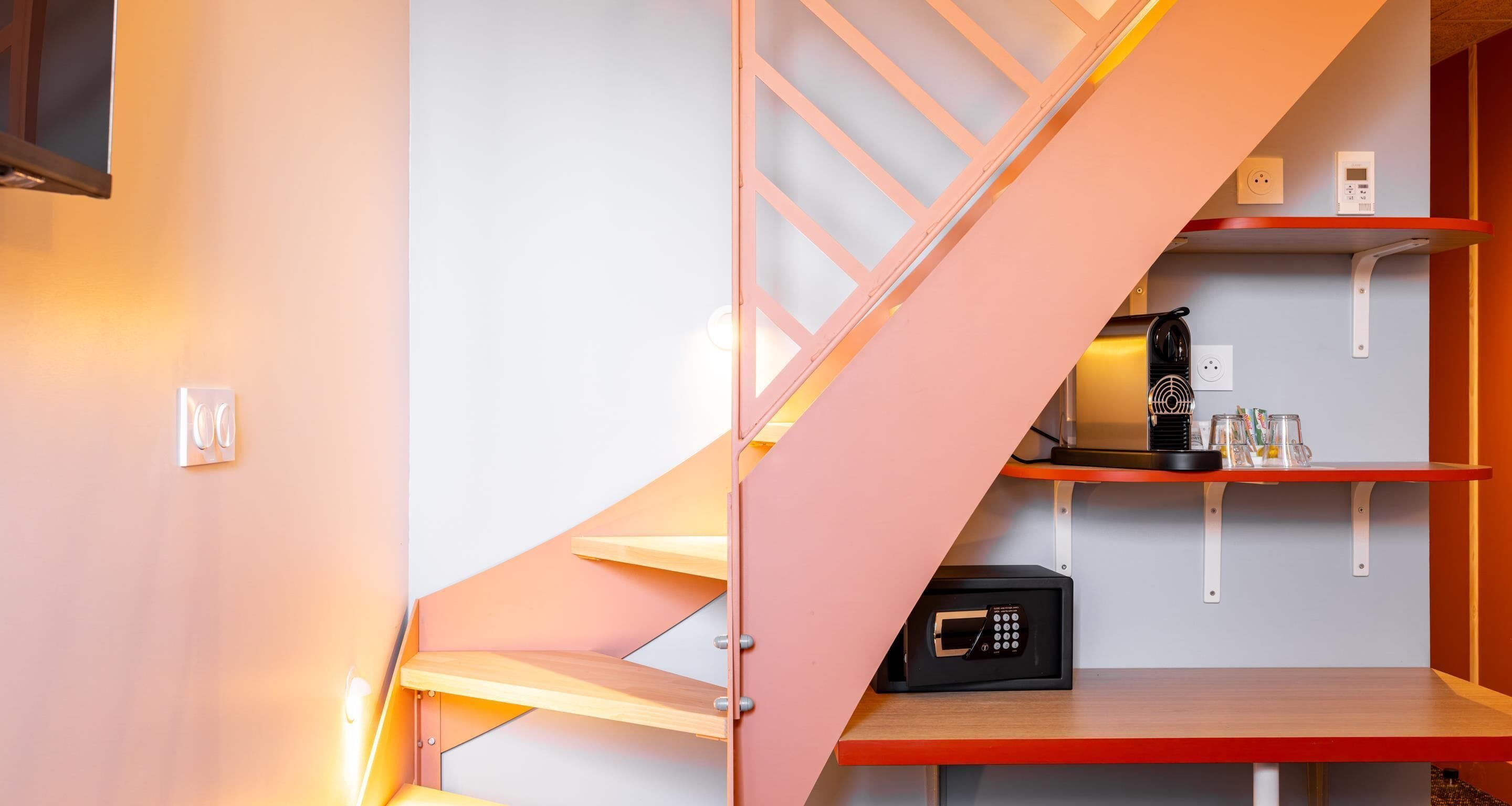 A modern staircase with built-in shelves, a coffee machine, and a microwave.