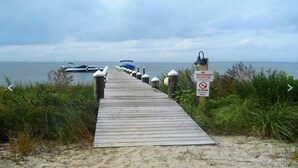 A wooden boardwalk leading to a beach with a sign indicating no trespassing and no diving. - 402SunsetBeach,PenthouseDir.WaterFrt,Pvt.Beach,Pool,Elev,1Blk Seacrets3BDRM/3FBH (Ocean City)