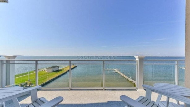 A balcony with a clear view of the sea, a grassy area, and a pier. - 402SunsetBeach,PenthouseDir.WaterFrt,Pvt.Beach,Pool,Elev,1Blk Seacrets3BDRM/3FBH (Ocean City)