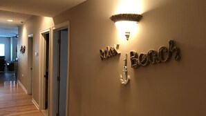 A hallway with a sign reading "West Branch" and an anchor symbol. - 4 Bdr - POOL - Steps to BEACH - Elevator (Wildwood Crest)