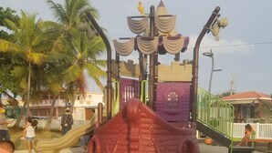A playground with a slide and climbing structures.