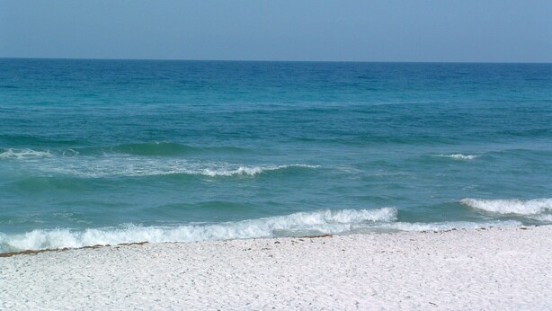 A beach with clear blue water and a sandy shore. - Spacious Home. Short Walk to Beach, Beach Shuttle & Shunk Gulley. Pet Friendly! (Santa Rosa Beach)