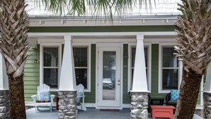 A house with a porch, white columns, and a green exterior. - Spacious Home. Short Walk to Beach, Beach Shuttle & Shunk Gulley. Pet Friendly! (Santa Rosa Beach)