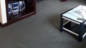 A hotel room with a bed, a television, a coffee table, and a bookshelf. - Residency Suites At Times Square (Kuala Lumpur)