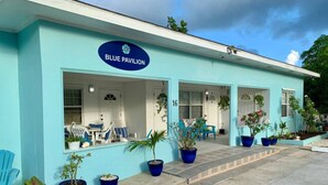 A building with a sign reading "BLUE PAVILION" and numbered rooms. - S3 BP| Steps to Beach | Save 15% if Book Non-Refundable (West Bay)