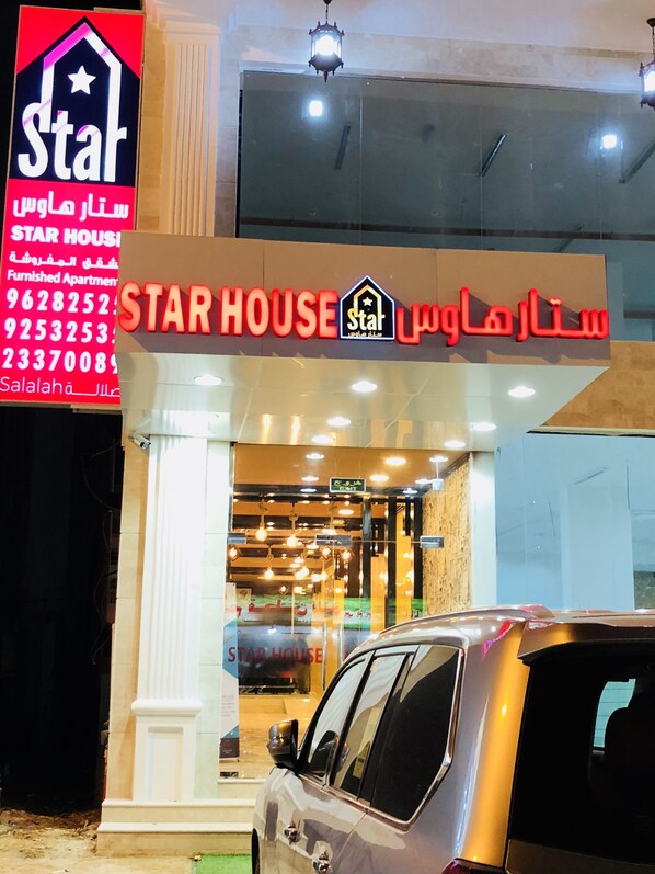 Ein Star House Gebäude mit einer Schautafel, welche Kontaktdaten und den Namen 'Star House' zeigt.