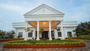 A building with a sign reading "Pacific Convention Hall" and a symmetrical facade with columns and a triangular pediment. - The Ocean Pearl Resort And Spa (Dharwad)