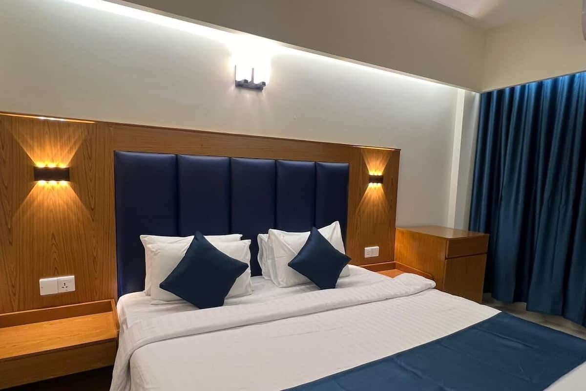 Premium bedding, desk, laptop workspace, blackout drapes