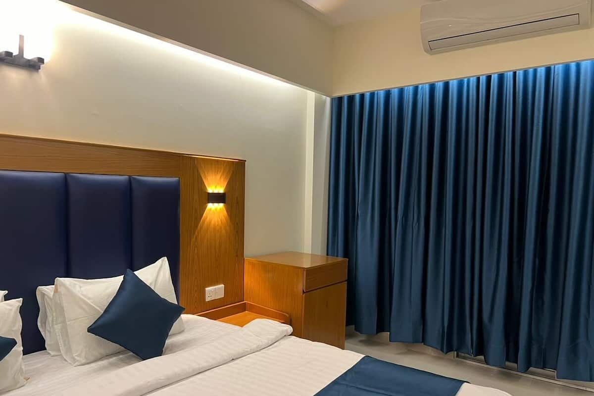 Premium bedding, desk, laptop workspace, blackout drapes