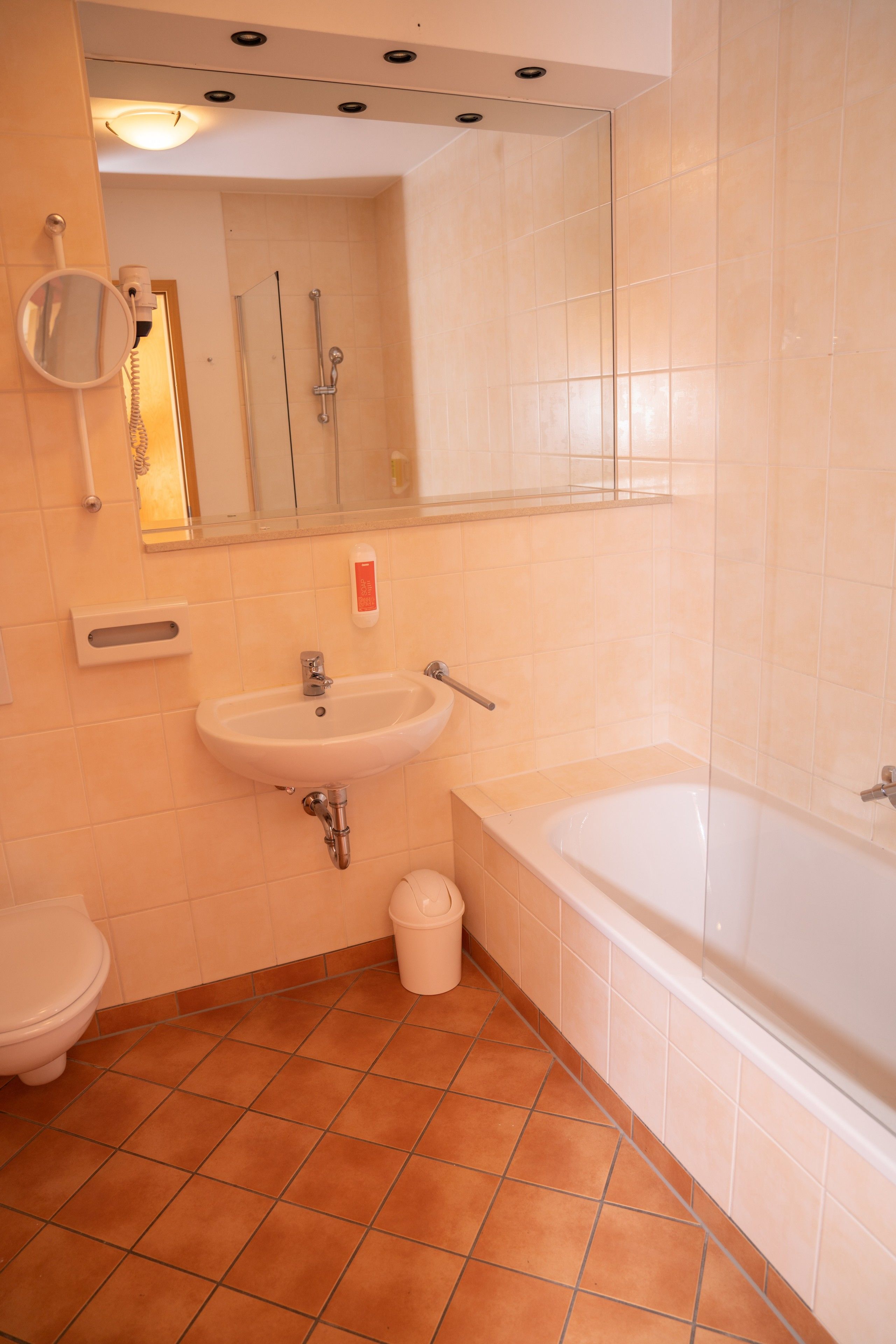 A bathroom with a white sink, toilet, and bathtub.