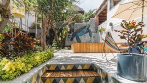 A wooden staircase leading to a pool area with a hammock and a potted plant. - Amaia Boutique Hotel (Sayulita)