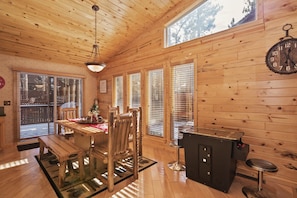 Enjoy meals and refreshments at the communal dining table or bar counter, surrounded by rustic charm.