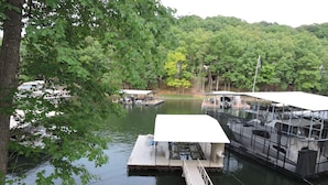 A dock with a covered boat house, a floating dock, and a small pier. - Great Location!  Heart of Horseshoe Bend-2MM in Lake of the Ozarks. (Lake Ozark)