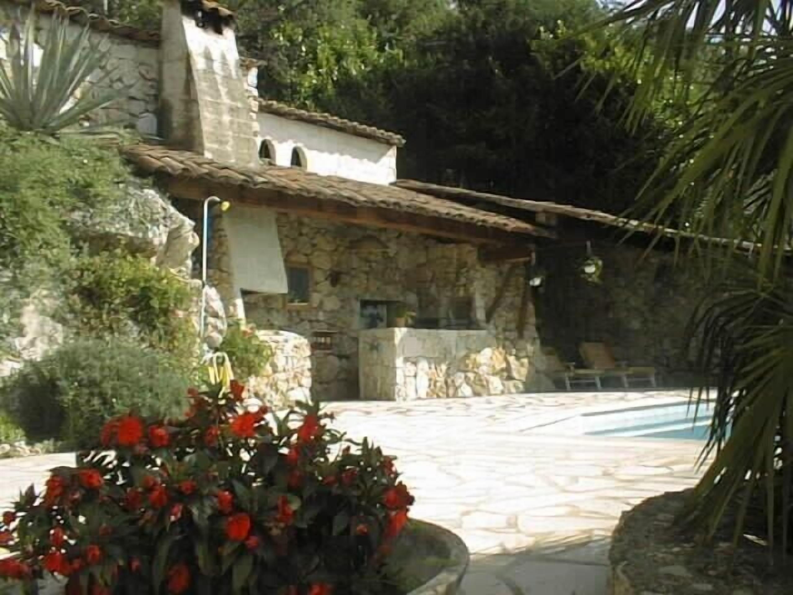 The stone pool house and BBQ