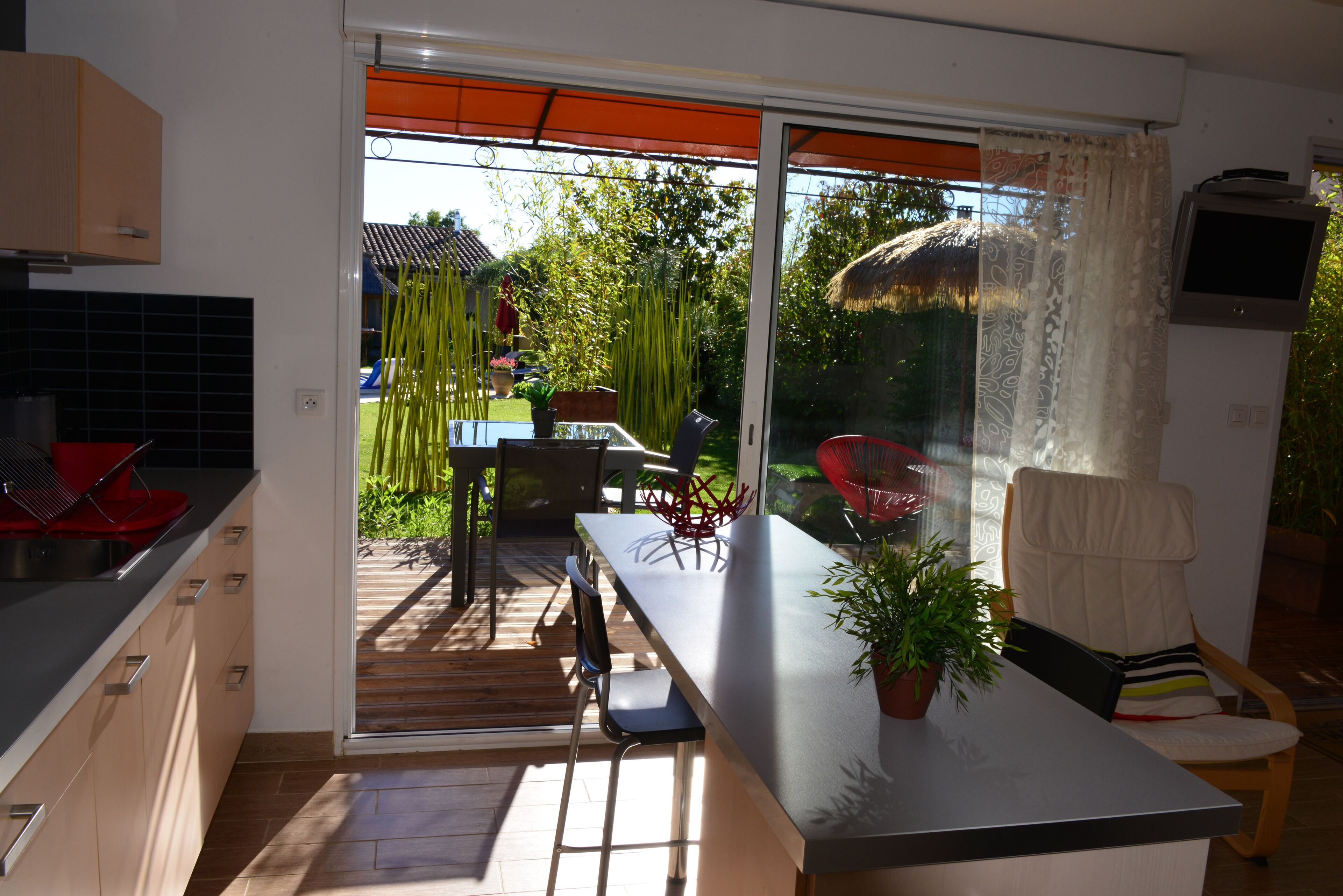 A modern kitchen with a sliding glass door leading to a patio area.