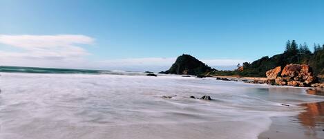 A beach with clear skies and calm waters.