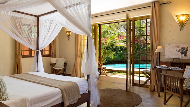 A bedroom with a four-poster bed, a view of a swimming pool, and a painting on the wall. - Kili Villa (Arusha)