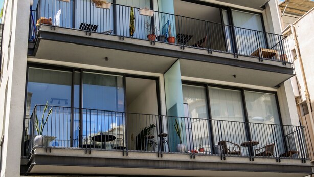 A multi-story residential building with balconies, large windows, and outdoor plants. - CTLV - Tchernikhovski 19 (Tel Aviv)