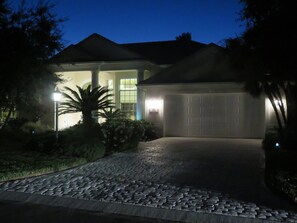 Stroll through the beautifully manicured lawn, past the palm tree, to the inviting entrance.