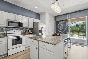 Enjoy cooking in this well-equipped kitchen with a large island and bar seating.