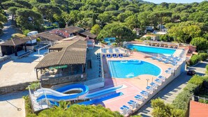 A resort with a large swimming pool, a water slide, and lounge areas. - SAINT-TROPEZ Bungalow in vacation park with pool - CÔTE D'AZUR  (Gassin)