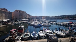 A marina with various boats docked, surrounded by buildings and a clear sky. - SAINT-TROPEZ Bungalow in vacation park with pool - CÔTE D'AZUR  (Gassin)