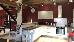 A modern kitchen with white cabinets, a wooden ceiling, and a red accent wall. - Traditional sluice-gate truss hones some on 10 hectares of ground-swimming pool (Gourdon)