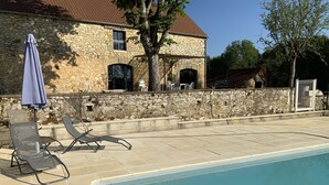 A stone building with a pool, outdoor chairs, and a covered seating area. - Traditional sluice-gate truss hones some on 10 hectares of ground-swimming pool (Gourdon)
