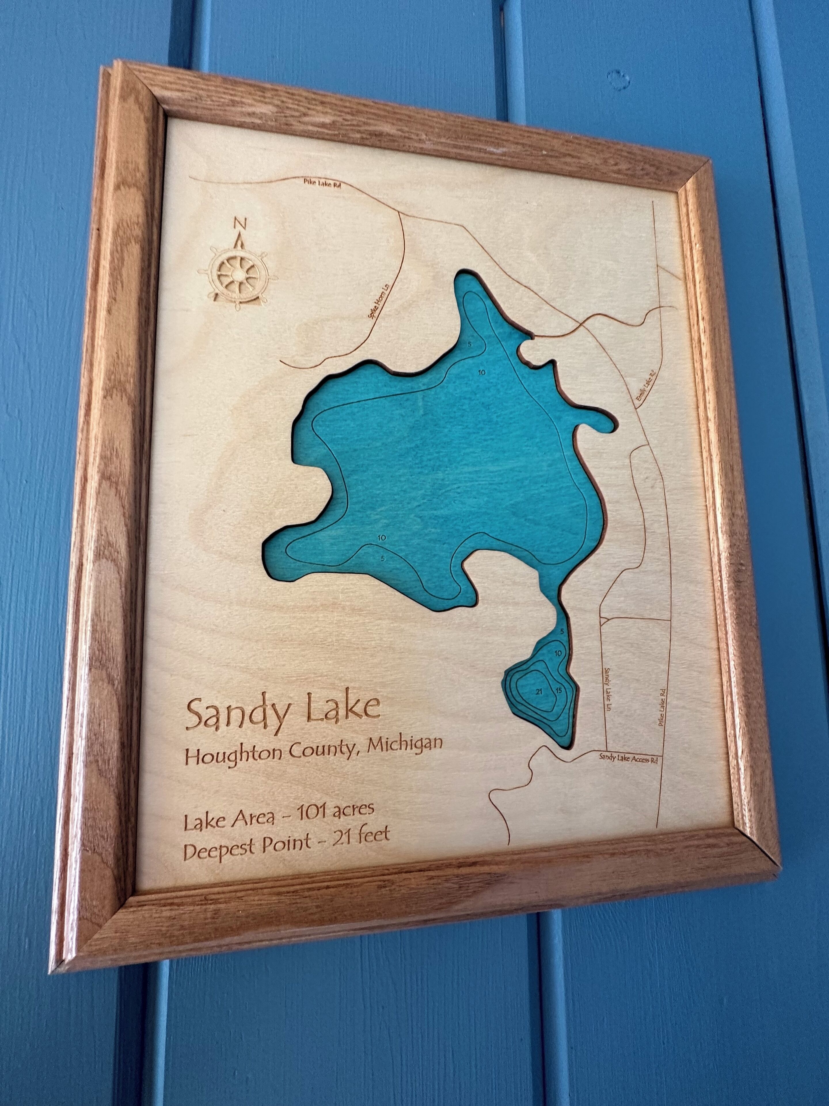 A framed map of Sandy Lake in Houghton County, Michigan, including lake area and deepest point.