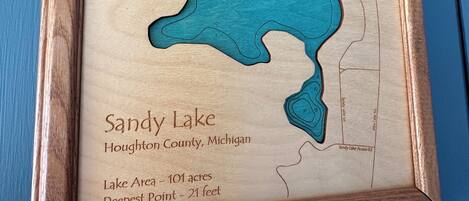 A framed map of Sandy Lake in Houghton County, Michigan, including lake area and deepest point.