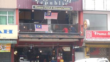 A two-story building with a sign reading "Big Mouth Republic" and "Western Food & Oriental Cuisine".