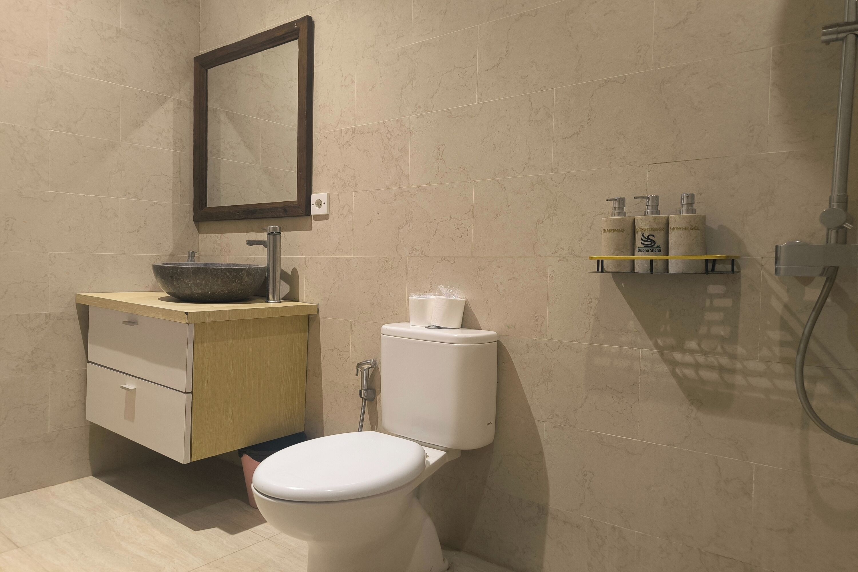 A modern bathroom with a toilet, sink, and shower.