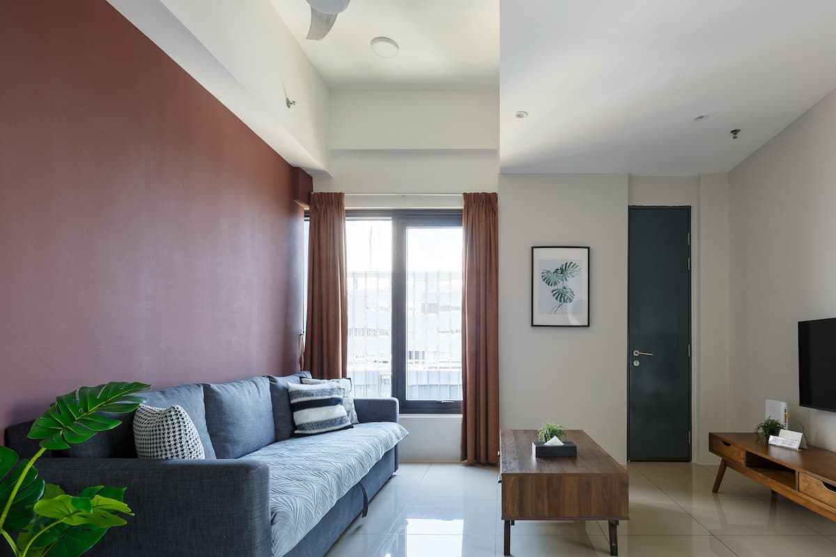 A modern living room with a sofa, coffee table, and TV.