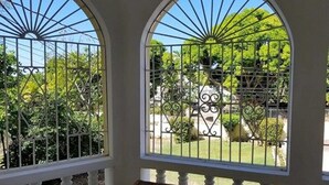 A room with a view of a garden through a barred window. - Marantha Close (Montego Bay)