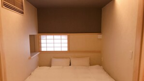 A narrow room with a bed, a window, and a shelf. - Shiki Shiki Ponto (Kyoto)
