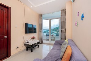 Basic Apartment, 1 King Bed, Non Smoking | Living area | Fireplace, books - Cozzy Seaview Apartment (Ho Chi Minh City)