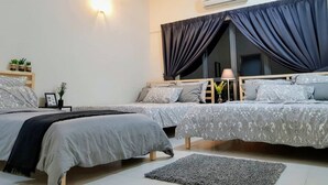 A modern bedroom with two beds, a ceiling fan, an air conditioning unit, and a window with curtains.