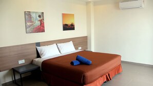 A hotel room with a bed, a nightstand, and two paintings on the wall. - Hotel ASRC (Alor Setar)