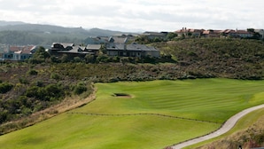 A golf course with a well-maintained fairway and a clubhouse in the background. - Villa 9 (Knysna)