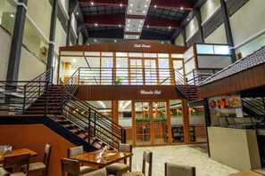 A multi-level restaurant with a staircase, wooden facade, and a sign reading "Club House." - Sunstar Residency & Food Plaza Pala (Meenachil)