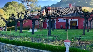 A red building with a sign reading "RESTAURANT" in front of a stone wall.