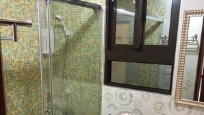 A bathroom with a shower, toilet, and sink. - Home of 120 B&B (Jiaoxi)