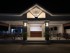 A hotel entrance with a sign reading "SEABREEZE LODGE".