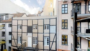 Un edificio de varios pisos con un estilo arquitectónico particular, que combina paneles blancos y de color oscuro.