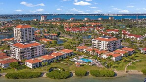 A resort with multiple buildings, a swimming pool, and a view of the ocean. - Penthouse Paradise with Amazing Views: 2BD, 2BA - (Isla Del Sol)
