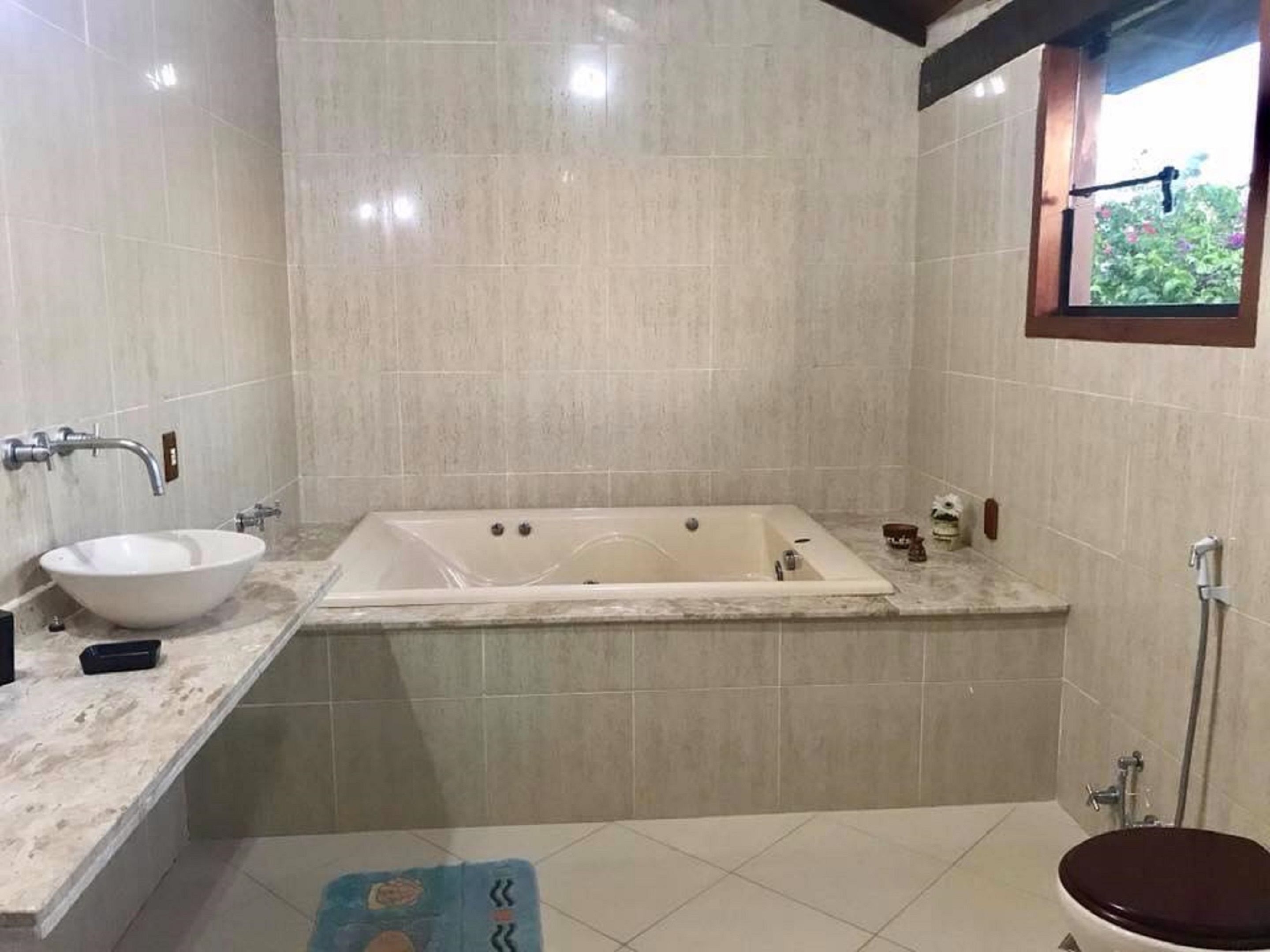 A bathroom with a bathtub, a sink, and a toilet.